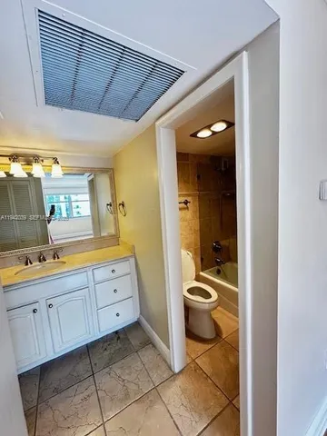 a spacious bathroom with a granite countertop sink and a mirror