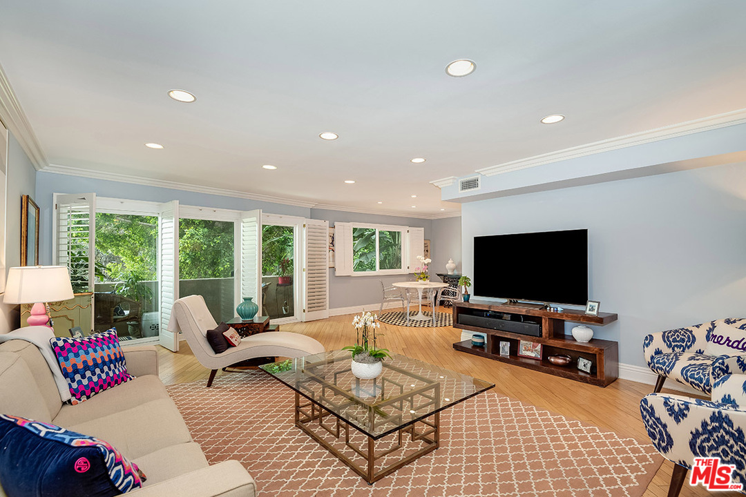 8963 Burton Way, Unit 203 Los Angeles, CA 90048 - Photo 1 of 12 a living room with furniture and a flat screen tv