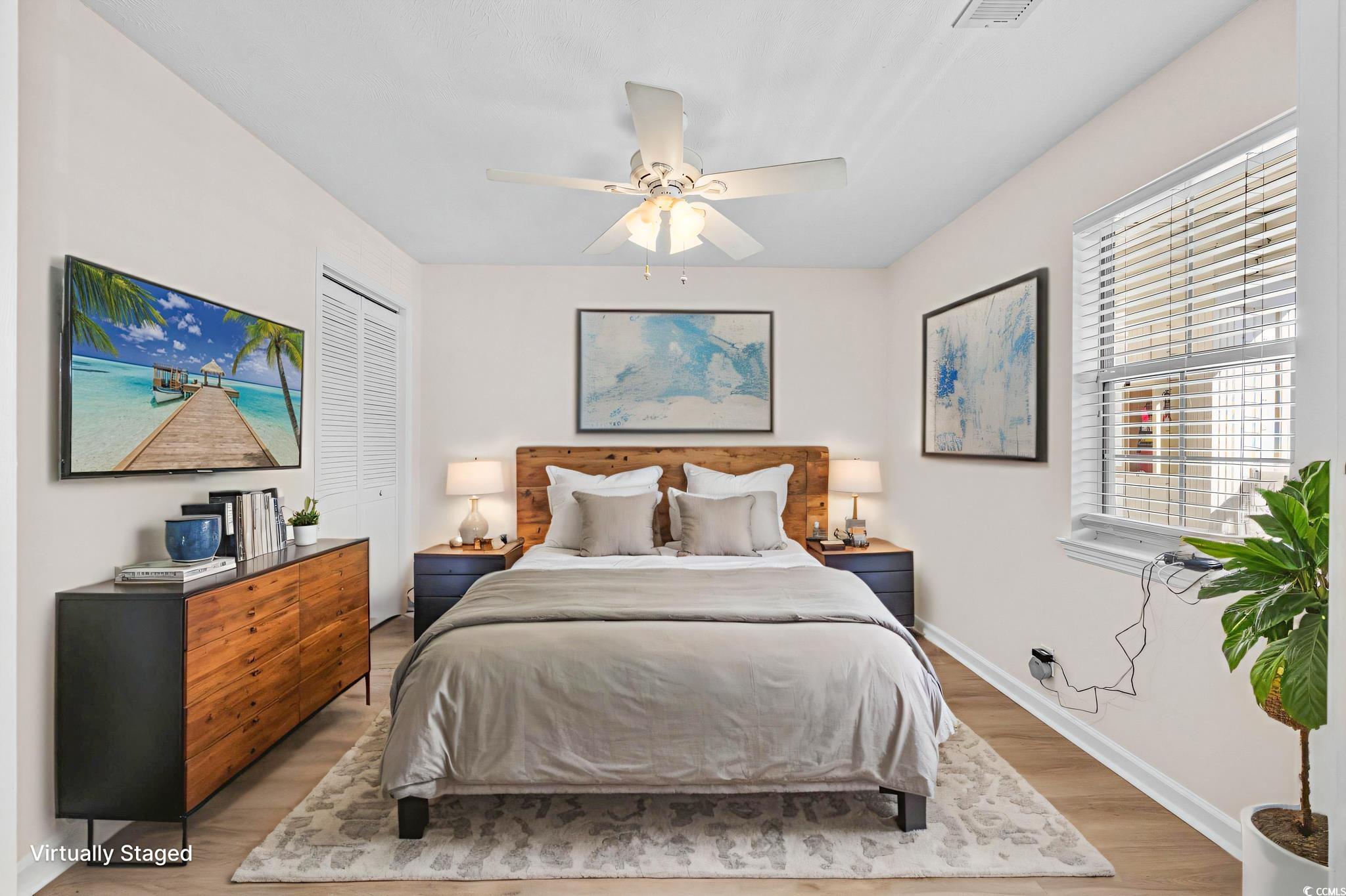 673 Tupelo Lane, Unit 19H Longs, SC 29568 - Photo 7 of 22 Bedroom featuring a closet, wood finished floors, and a ceiling fan