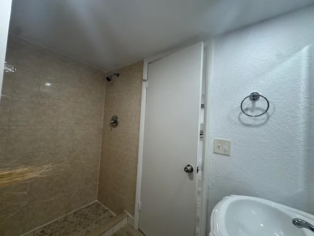 a bathroom with a sink and shower