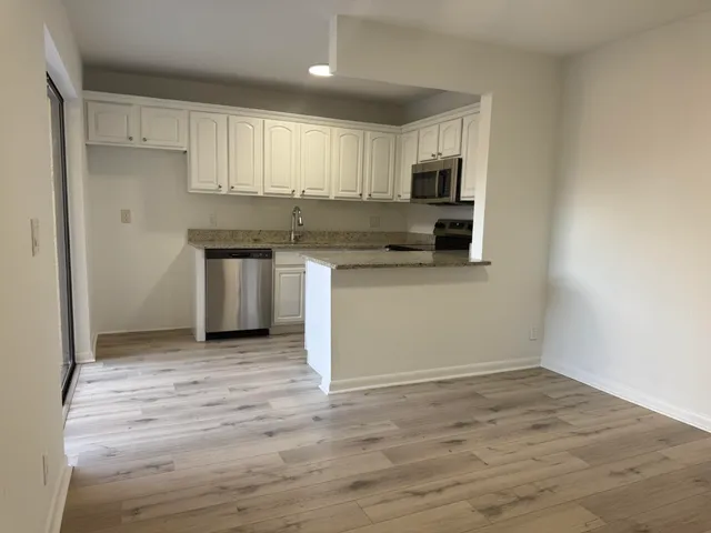 a kitchen with stainless steel appliances granite countertop a stove and a refrigerator