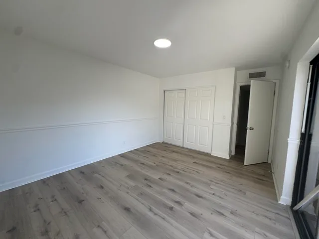 a view of an empty room and wooden floor