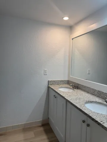 a bathroom with a granite countertop sink and vanity