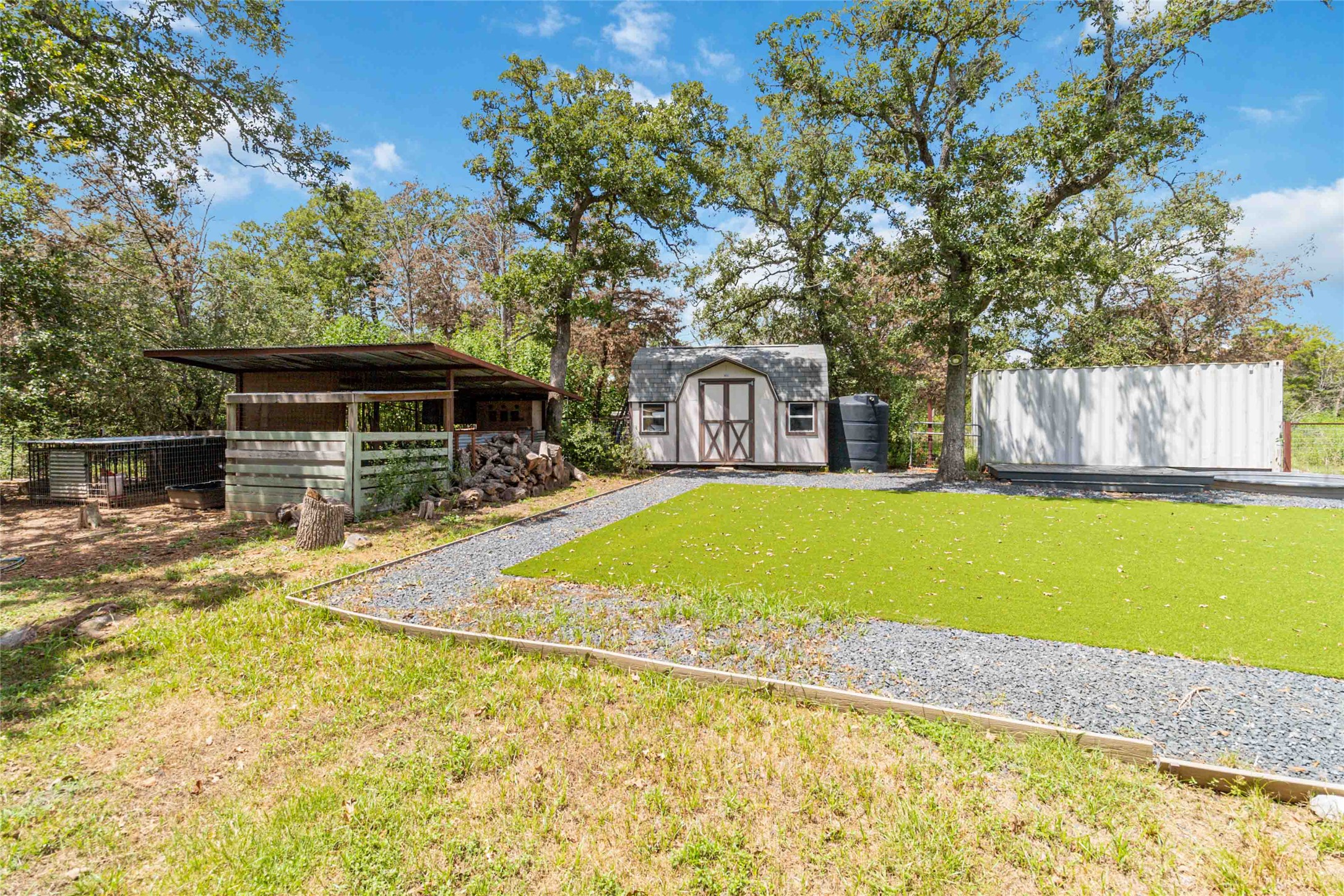 180 Ironstone Road Smithville, TX 78957 - Photo 35 of 37 View of yard featuring a storage unit