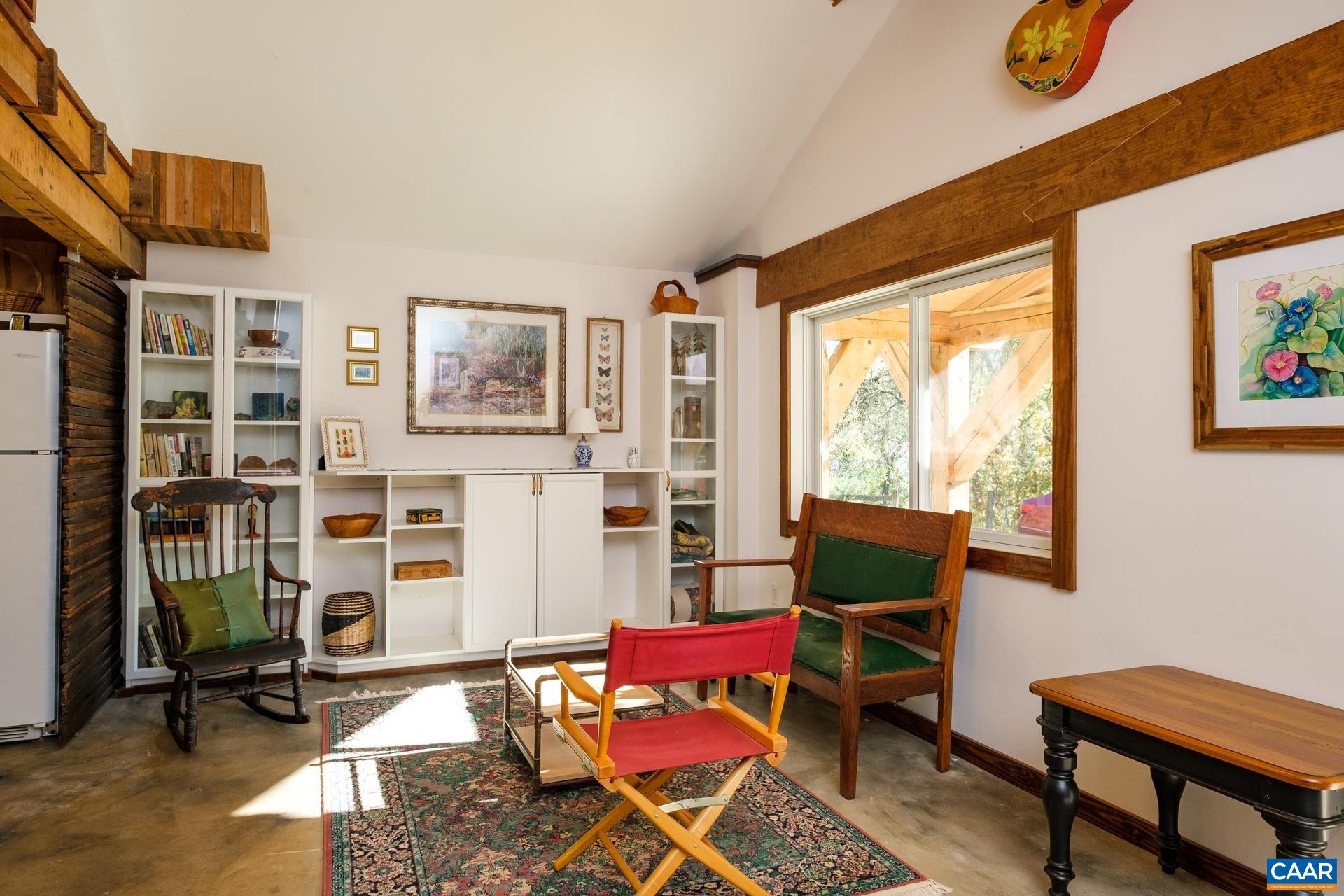 37 Pharsalia Road Roseland, VA 22967 - Photo 29 of 59 a living room with furniture a bookshelf and a window