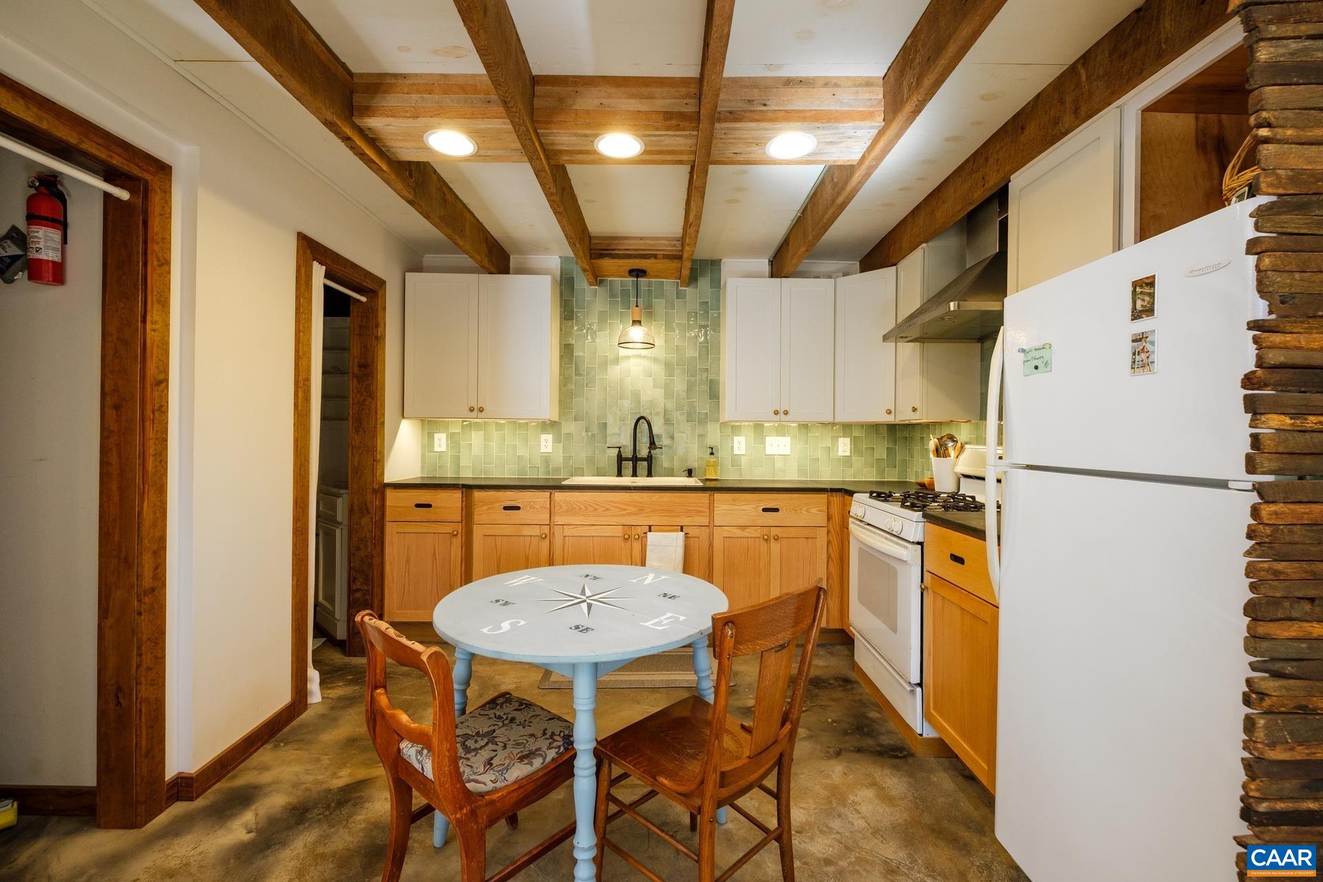 37 Pharsalia Road Roseland, VA 22967 - Photo 30 of 59 a kitchen with stainless steel appliances a refrigerator a stove a sink dishwasher with a dining table and chairs