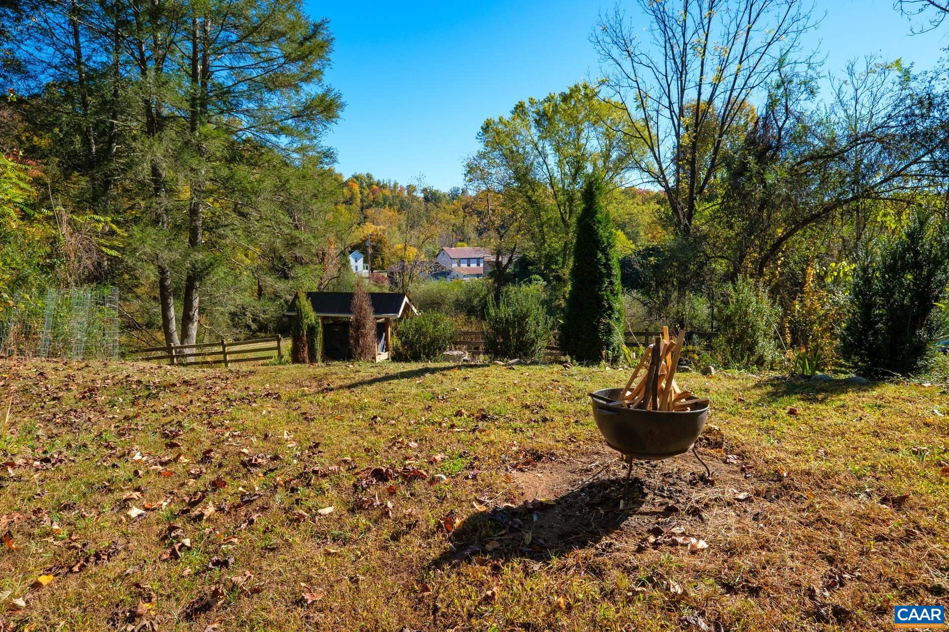 37 Pharsalia Road Roseland, VA 22967 - Photo 52 of 59 a backyard of a house with a fountain and large trees