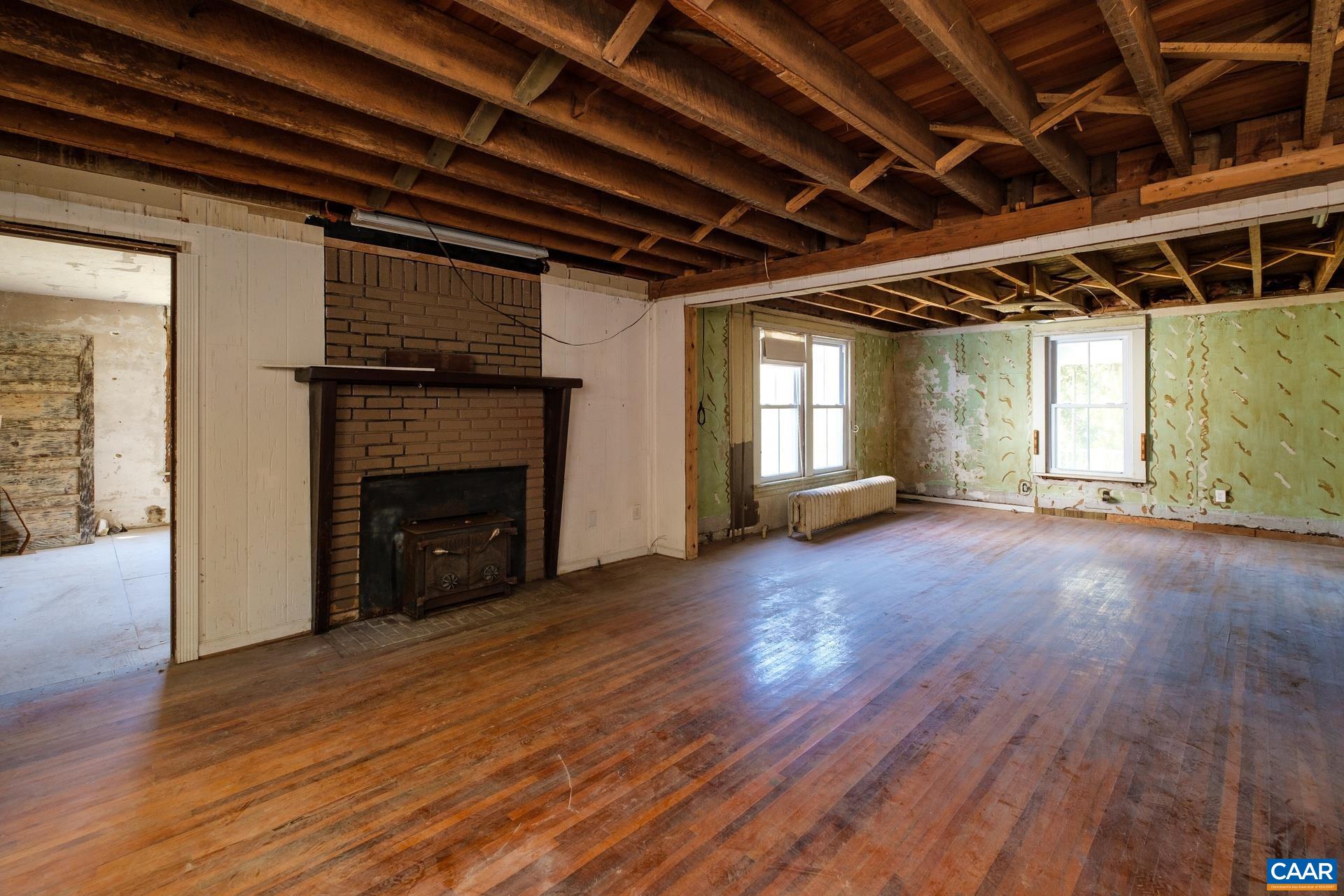 37 Pharsalia Road Roseland, VA 22967 - Photo 8 of 59 a view of empty room with wooden floor and fireplace