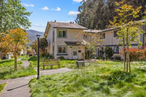a view of a house with a yard and tree s