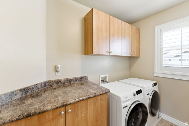 7235 Viansa Court Midvale, UT 84047 - Photo 23 of 43 Laundry room featuring washer and dryer and cabinet space