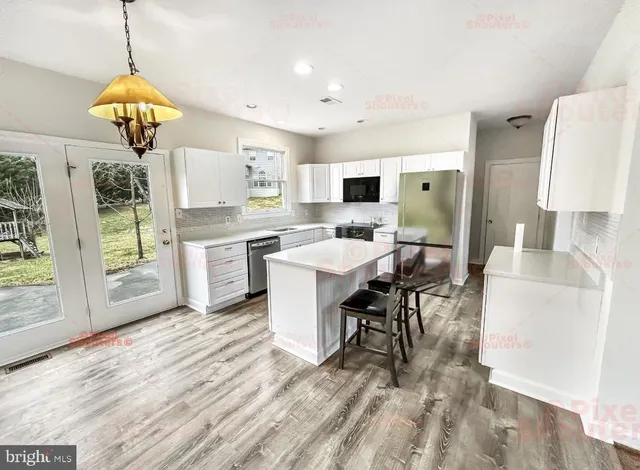 a view of kitchen with sink dining table and chairs