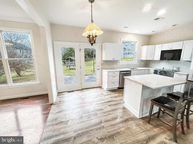 a kitchen with a sink stove and refrigerator