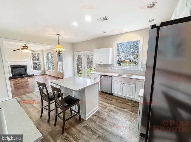 a kitchen with a table chairs sink and cabinets