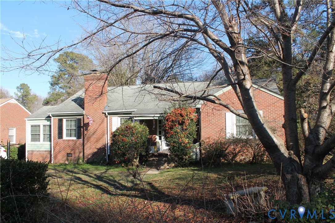 2709 Oak Hill Road Petersburg, VA 23805 - Photo 2 of 3 a view of a white house next to a yard with a fountain and large trees