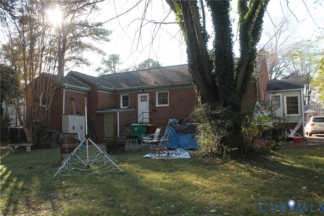 2709 Oak Hill Road Petersburg, VA 23805 - Photo 3 of 3 a view of backyard with table and chairs and potted plants and large trees