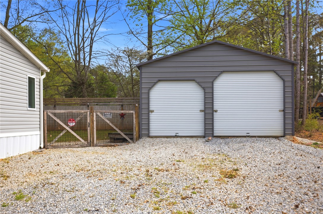 240 Southeast 147 Seneca, SC 29678 - Photo 3 of 27 This property features ample parking with a detached garage and fenced yard.