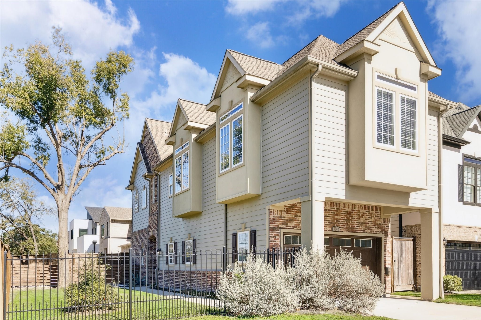 a front view of a residential apartment building with a yard