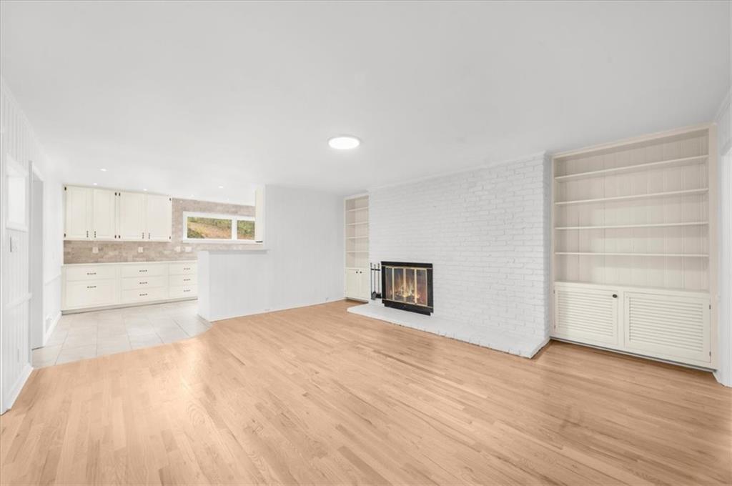 4890 High Point Road Northeast Sandy Springs, GA 30342 - Photo 15 of 35 a view of an empty room with a window and wooden floor