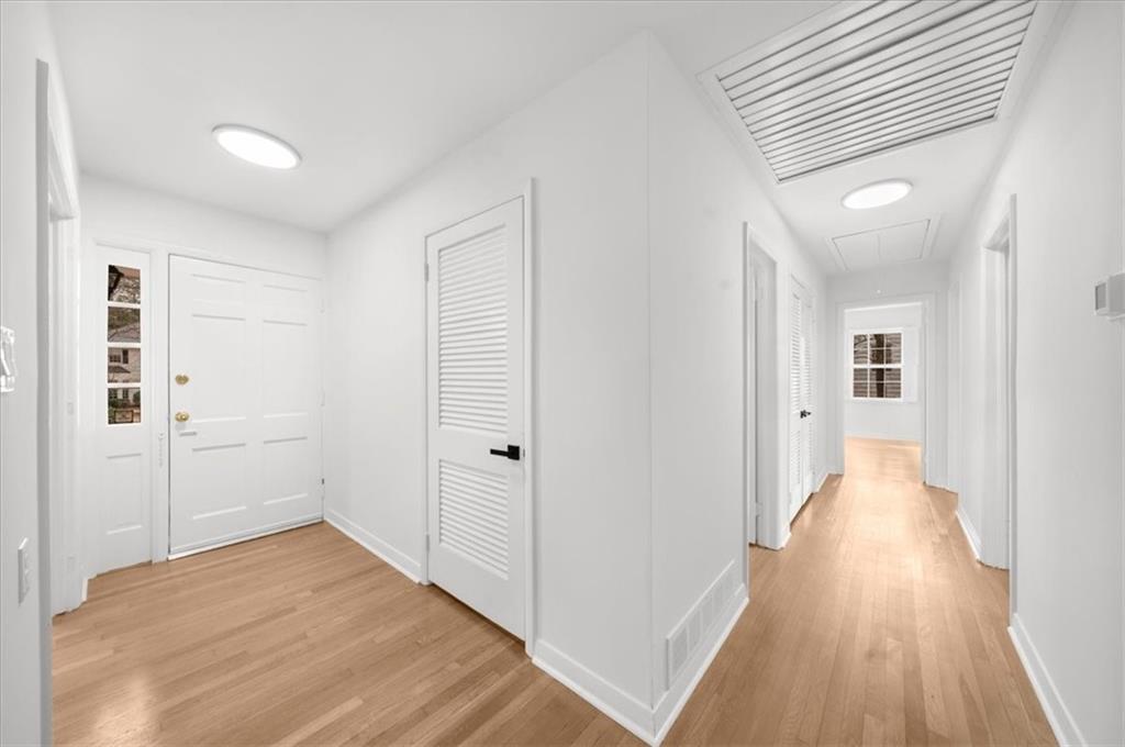 4890 High Point Road Northeast Sandy Springs, GA 30342 - Photo 18 of 35 a view of a hallway with wooden floor and closet