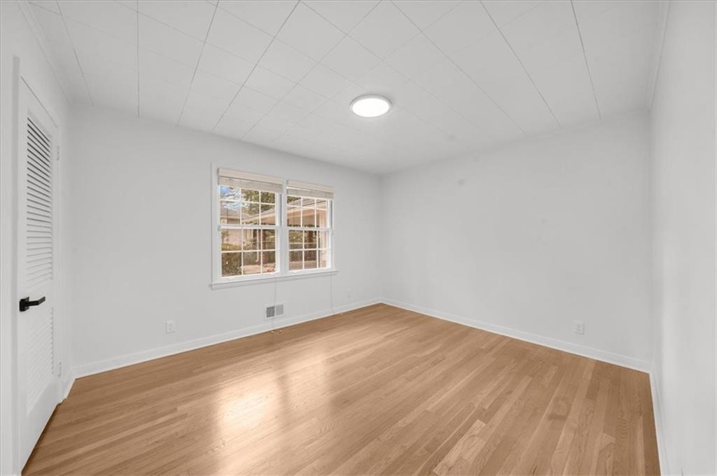 4890 High Point Road Northeast Sandy Springs, GA 30342 - Photo 20 of 35 a view of an empty room with wooden floor and a window