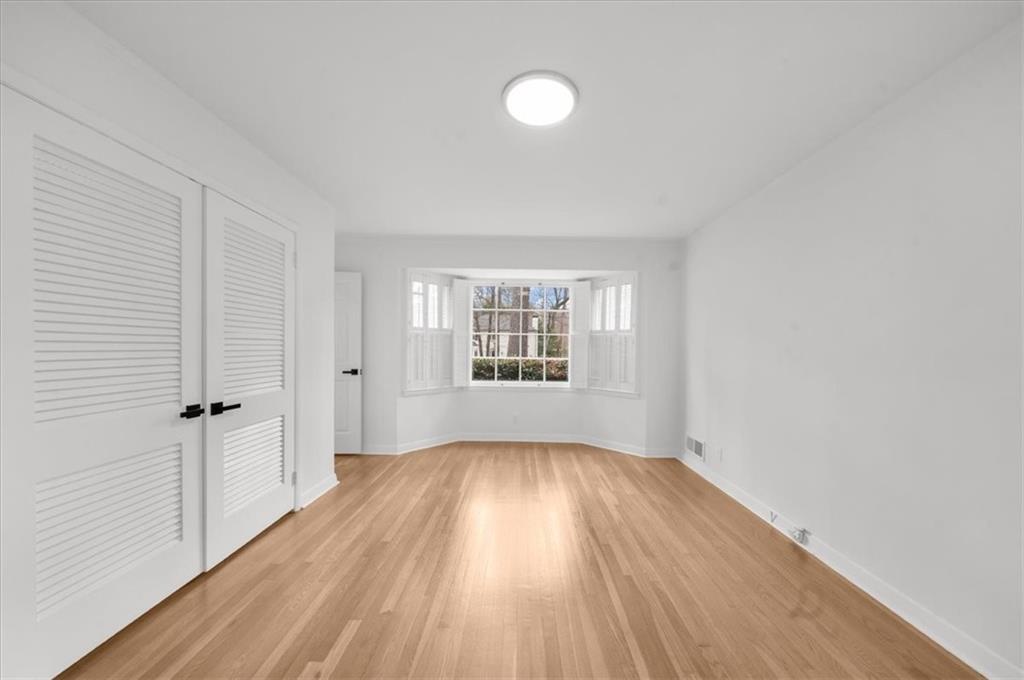 4890 High Point Road Northeast Sandy Springs, GA 30342 - Photo 22 of 35 wooden floor in an empty room with a window