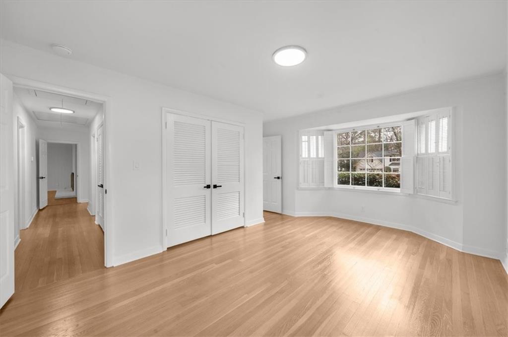 4890 High Point Road Northeast Sandy Springs, GA 30342 - Photo 23 of 35 a view of an empty room with wooden floor and a window