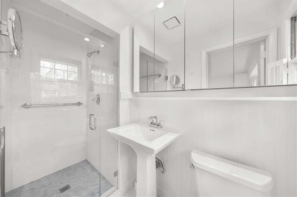 4890 High Point Road Northeast Sandy Springs, GA 30342 - Photo 25 of 35 a bathroom with a sink a toilet and mirror