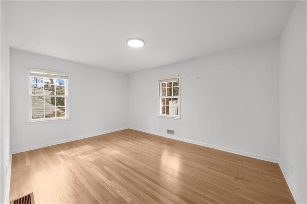 4890 High Point Road Northeast Sandy Springs, GA 30342 - Photo 28 of 35 an empty room with windows