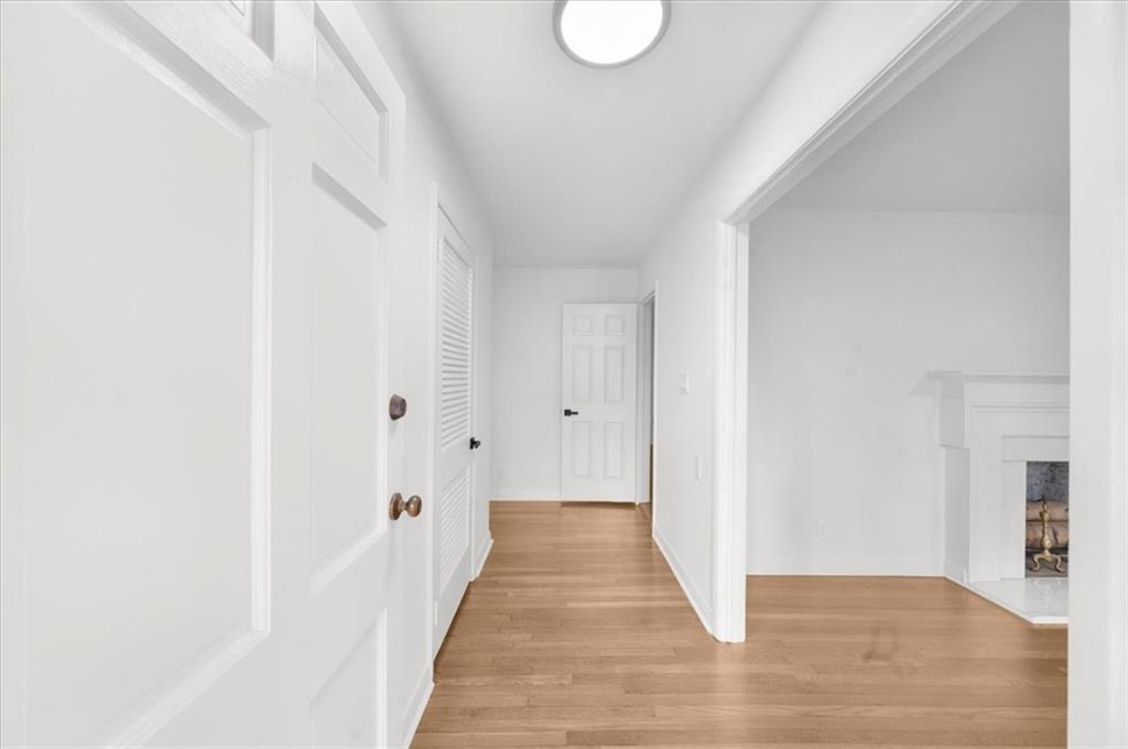 4890 High Point Road Northeast Sandy Springs, GA 30342 - Photo 3 of 35 a view of a hallway with wooden floor