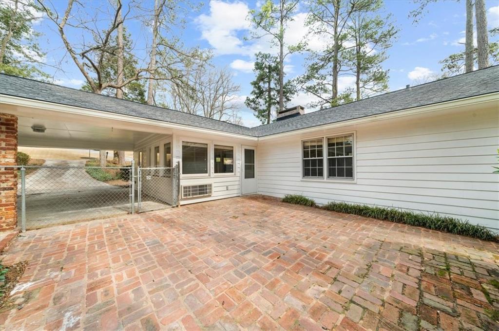 4890 High Point Road Northeast Sandy Springs, GA 30342 - Photo 31 of 35 a view of house with backyard and glass windows