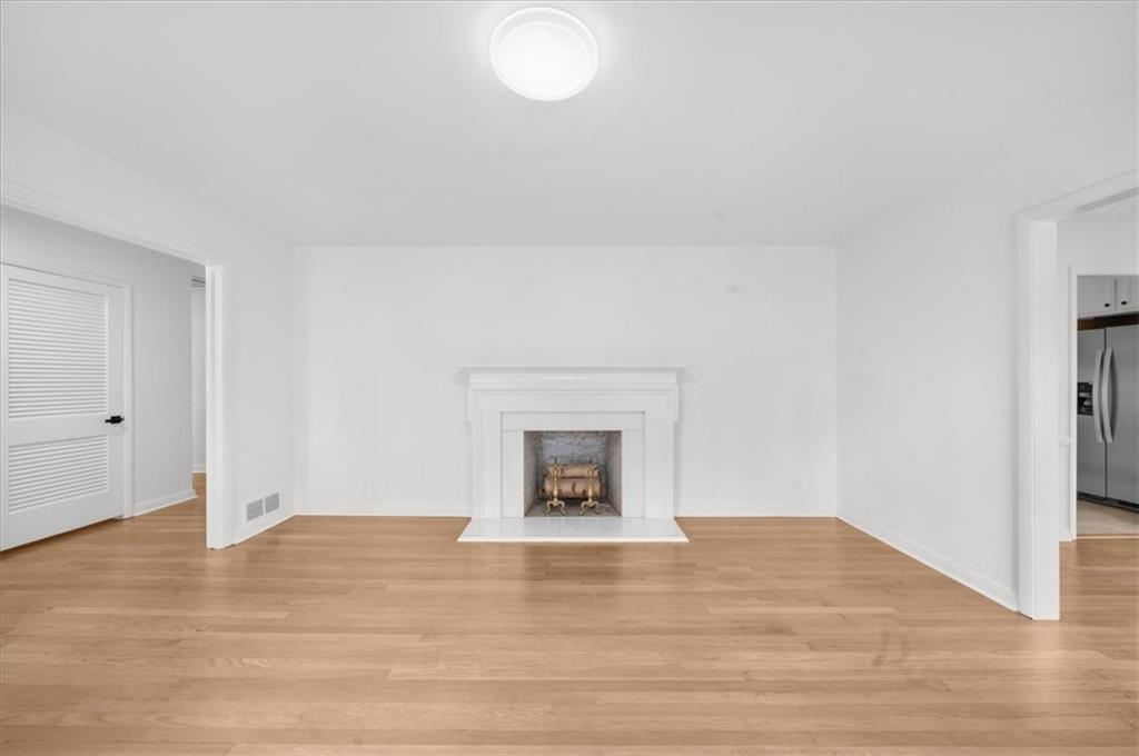 4890 High Point Road Northeast Sandy Springs, GA 30342 - Photo 4 of 35 a view of empty room with wooden floor