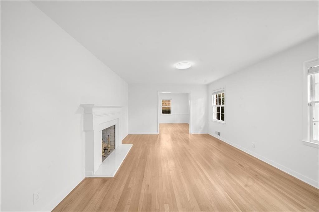 4890 High Point Road Northeast Sandy Springs, GA 30342 - Photo 5 of 35 a view of empty room with wooden floor