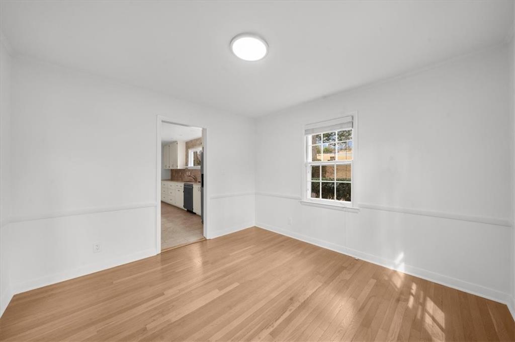 4890 High Point Road Northeast Sandy Springs, GA 30342 - Photo 7 of 35 a view of empty room with wooden floor and fan