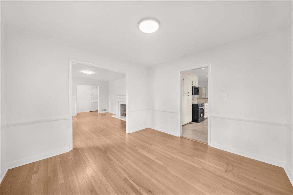 4890 High Point Road Northeast Sandy Springs, GA 30342 - Photo 8 of 35 a view of empty room with wooden floor