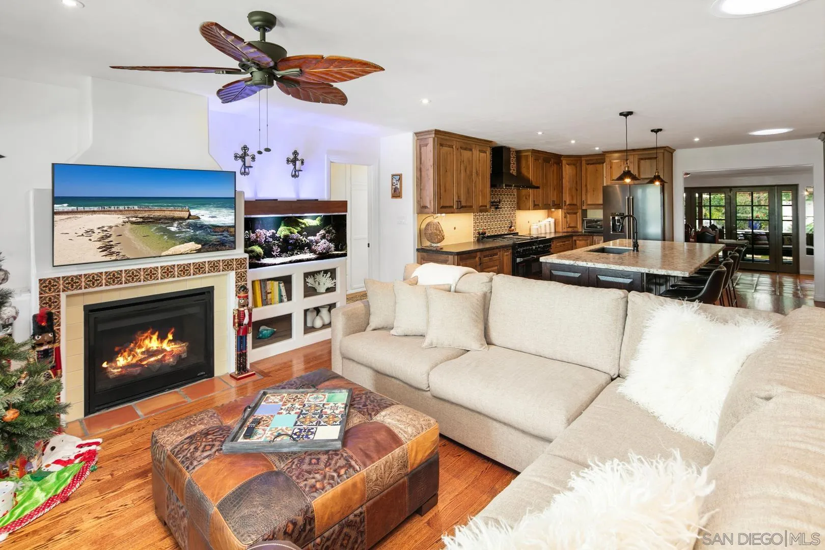 4195 Rochester Road San Diego, CA 92116 - Photo 12 of 39 a living room with furniture a fireplace and kitchen view