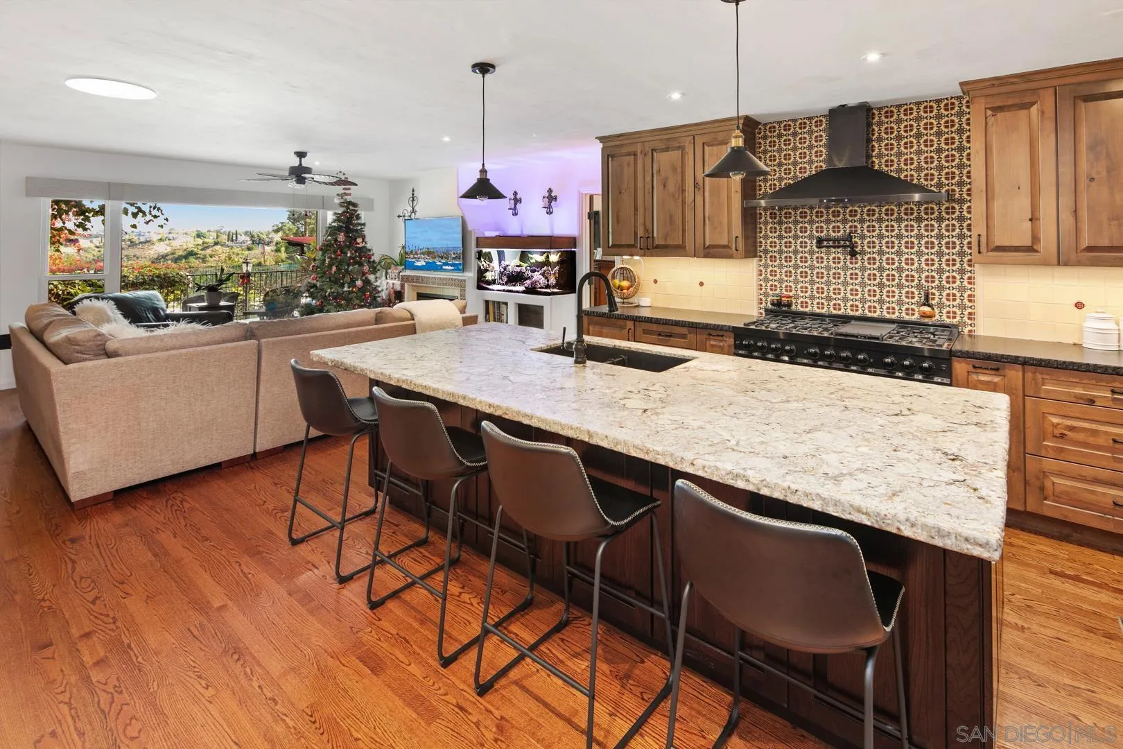 4195 Rochester Road San Diego, CA 92116 - Photo 19 of 39 a kitchen with granite countertop white cabinets and stainless steel appliances