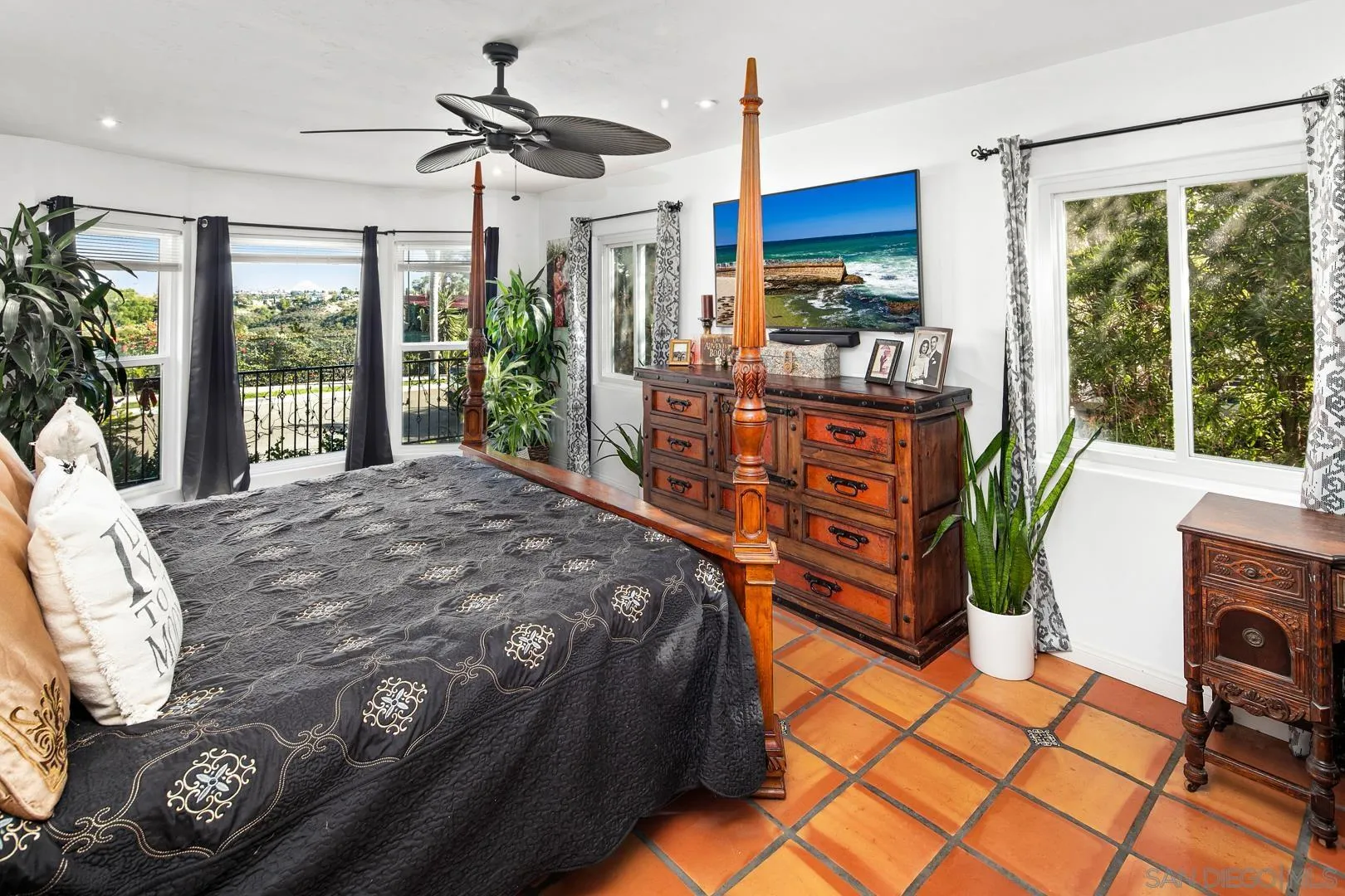 4195 Rochester Road San Diego, CA 92116 - Photo 27 of 39 a bedroom with a bed mirror and a large window