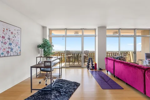 a living room with furniture and a floor to ceiling window
