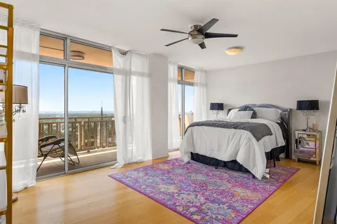 a bed sitting in a room next to a window