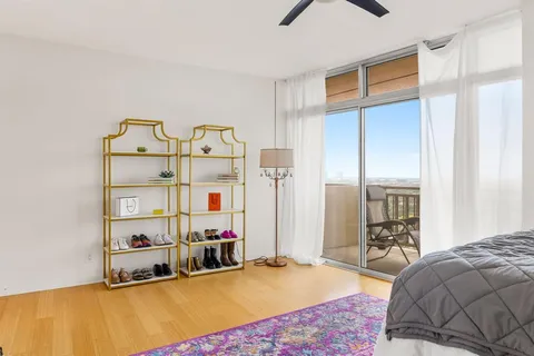 a bedroom with bed and a large window