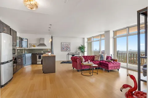 a dining room with furniture and a floor to ceiling window