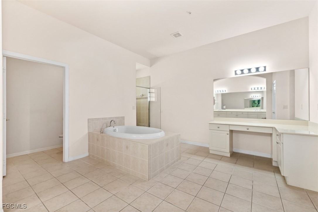 3520 Lansing Loop, Unit 203 Estero, FL 33928 - Photo 13 of 34 a bathroom with a sink a toilet and mirror