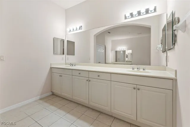 a spacious bathroom with a double vanity sink mirror and