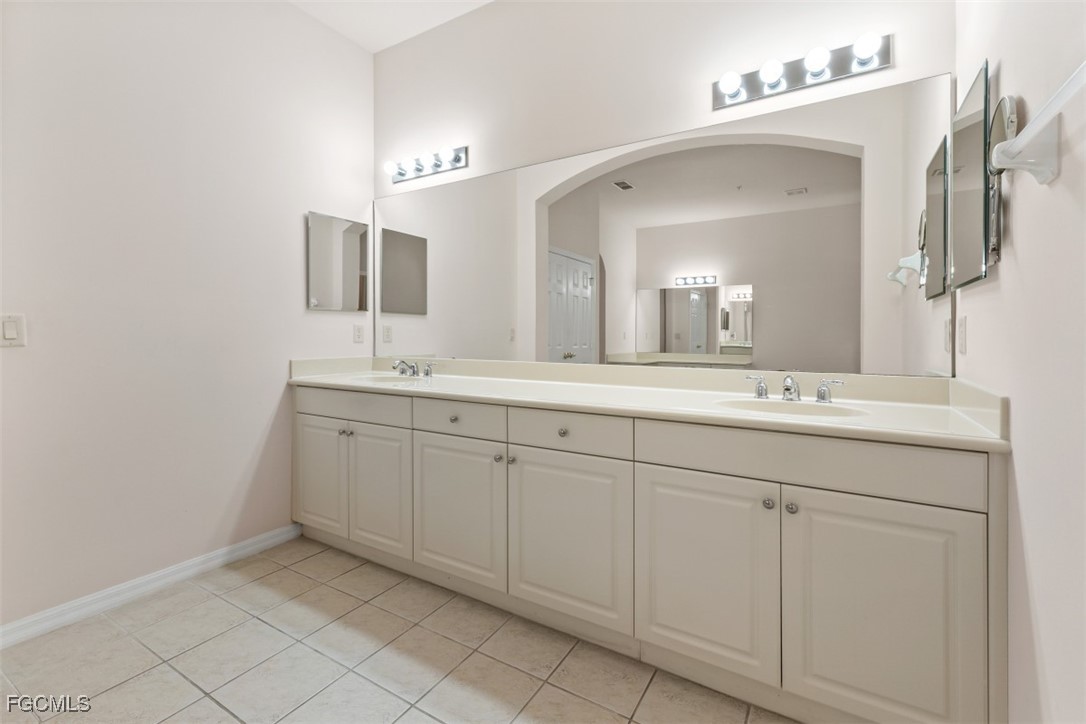 3520 Lansing Loop, Unit 203 Estero, FL 33928 - Photo 14 of 34 a spacious bathroom with a double vanity sink mirror and