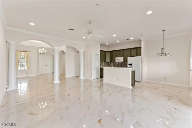 a view of a kitchen with a refrigerator and a stove top oven