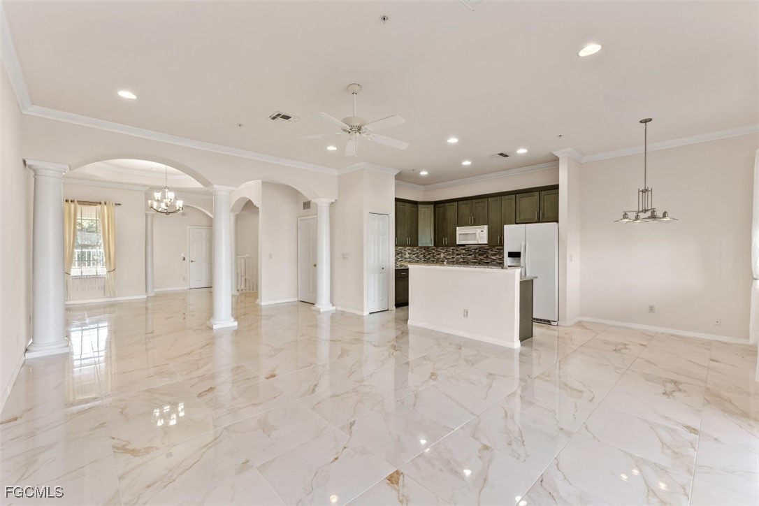 3520 Lansing Loop, Unit 203 Estero, FL 33928 - Photo 15 of 34 a view of a kitchen with a refrigerator and a stove top oven