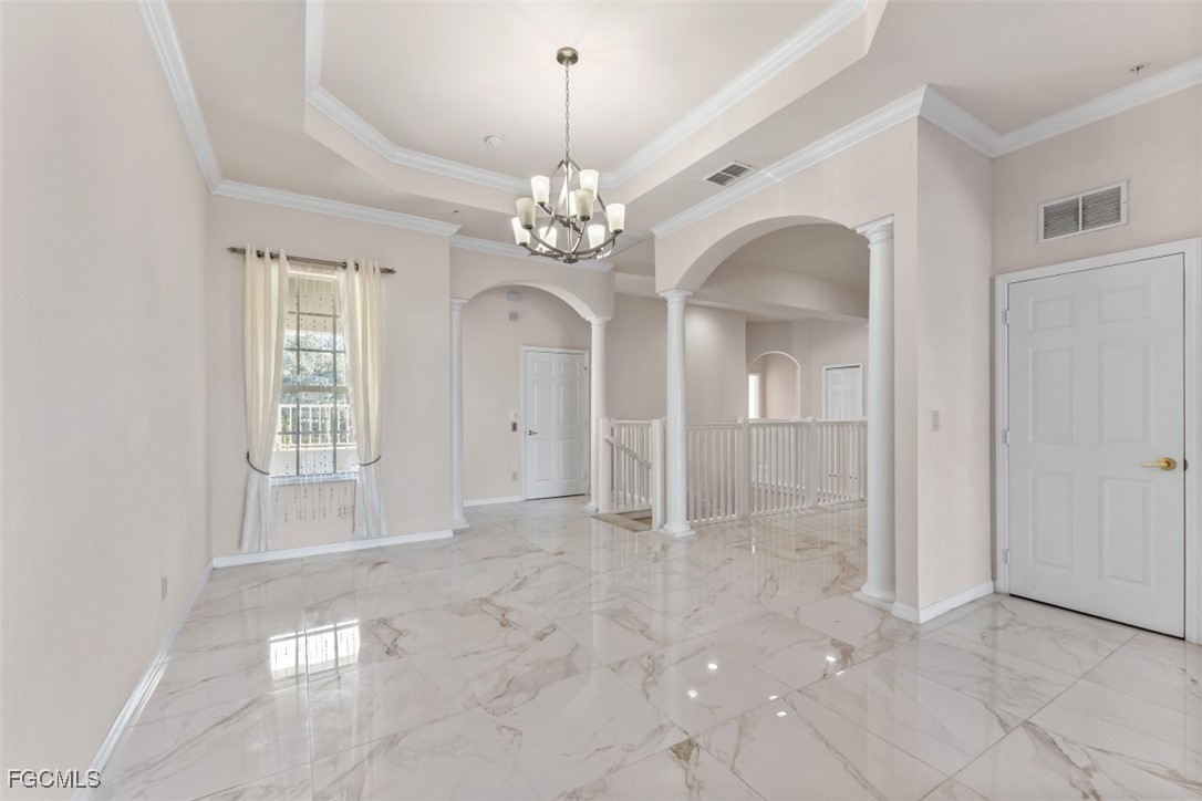 3520 Lansing Loop, Unit 203 Estero, FL 33928 - Photo 16 of 34 an empty room with chandelier and windows