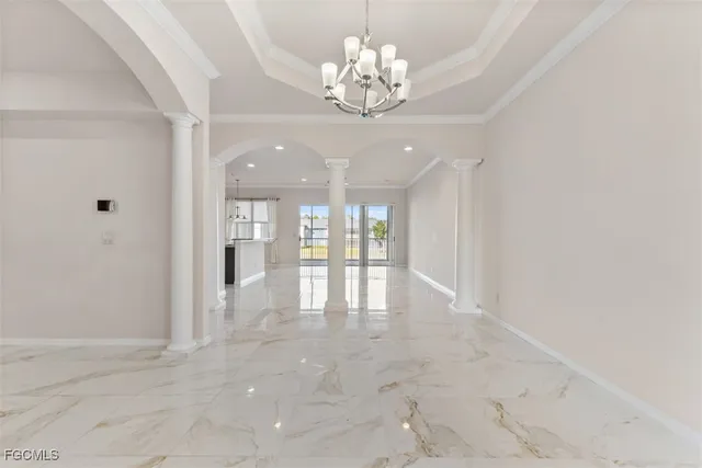 a view of an empty room with a chandelier