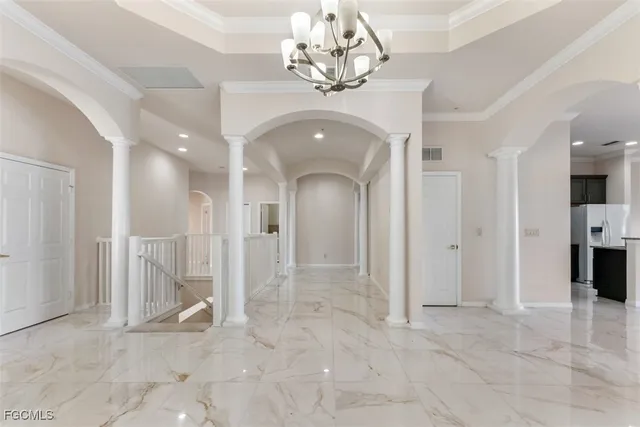 a view of a hallway with wooden shelves and chandelier