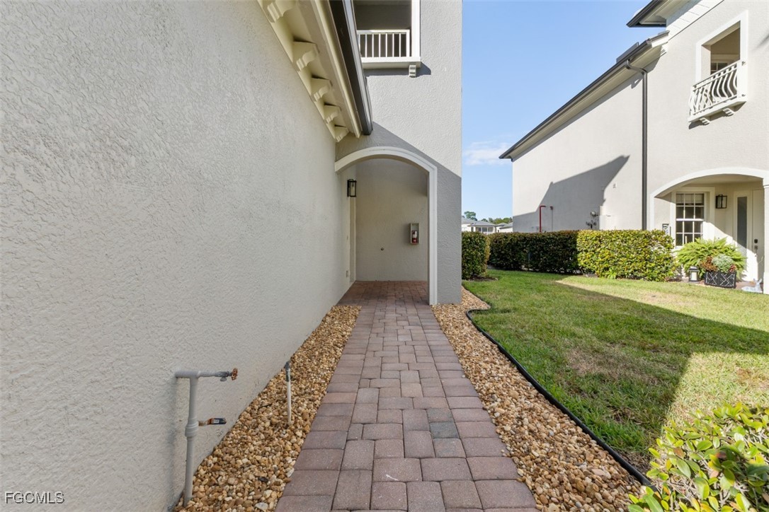 3520 Lansing Loop, Unit 203 Estero, FL 33928 - Photo 3 of 34 a view of a pathway of a house with a yard